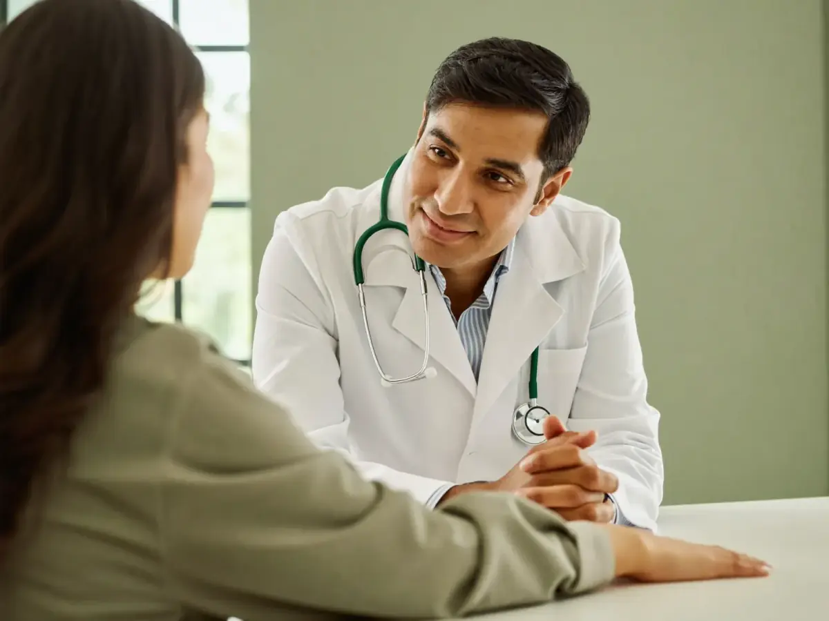 A doctor in a warm consultation with a member.